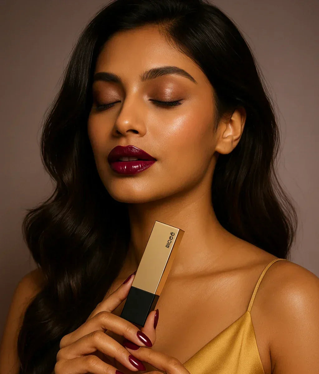 Woman holding a lipstick with a neutral background